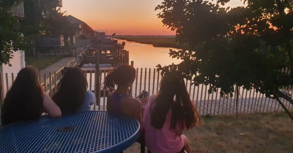 Gen Z teens watching sunset on vacation in Ocean City, MD