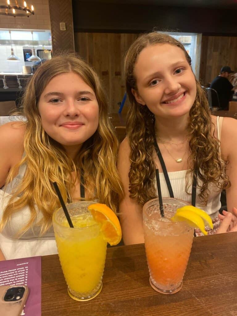 Two teen girls with mocktails smiling at Great Wolf Lodge