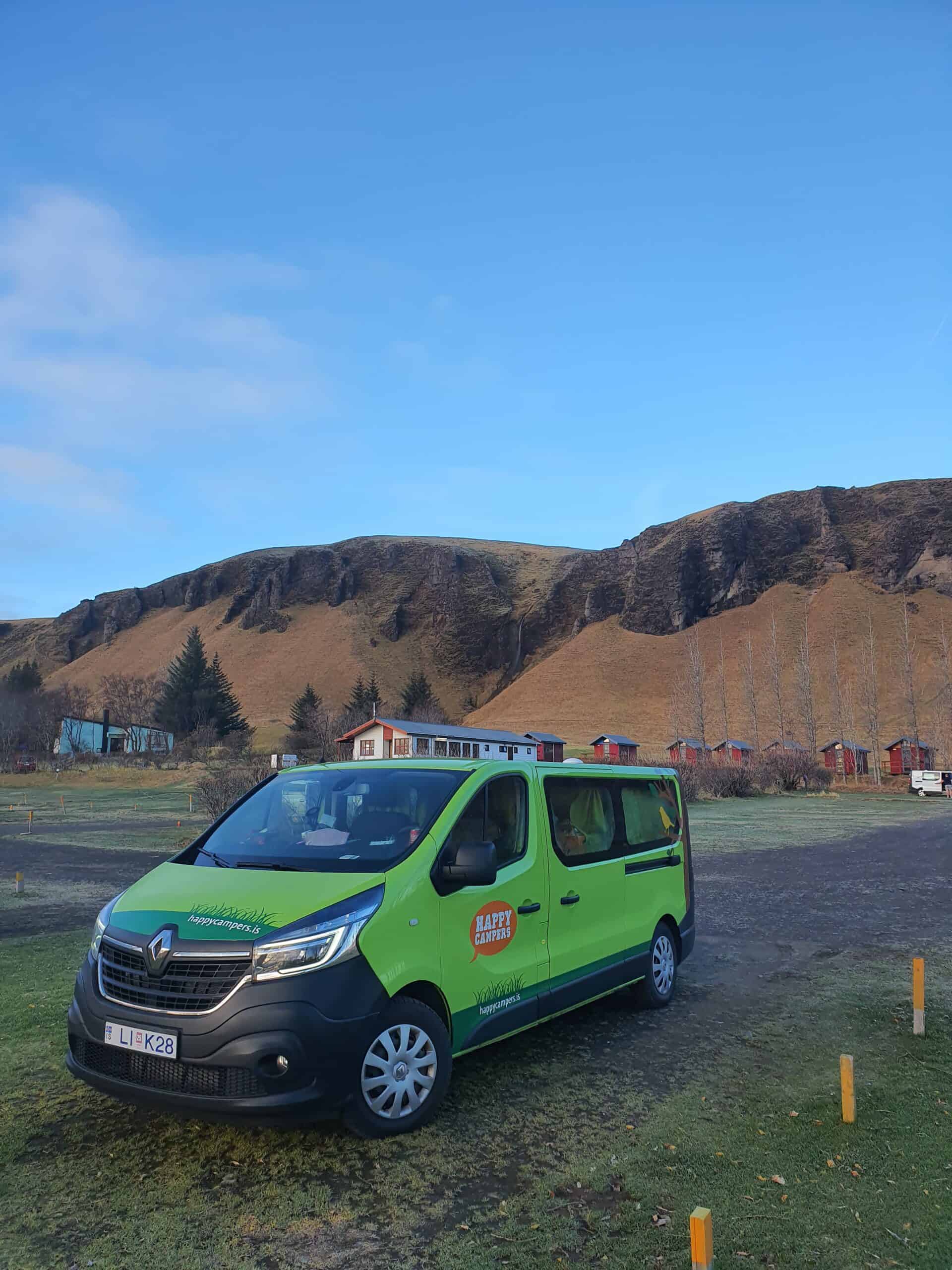 Green campervand parked in a campground in Iceland