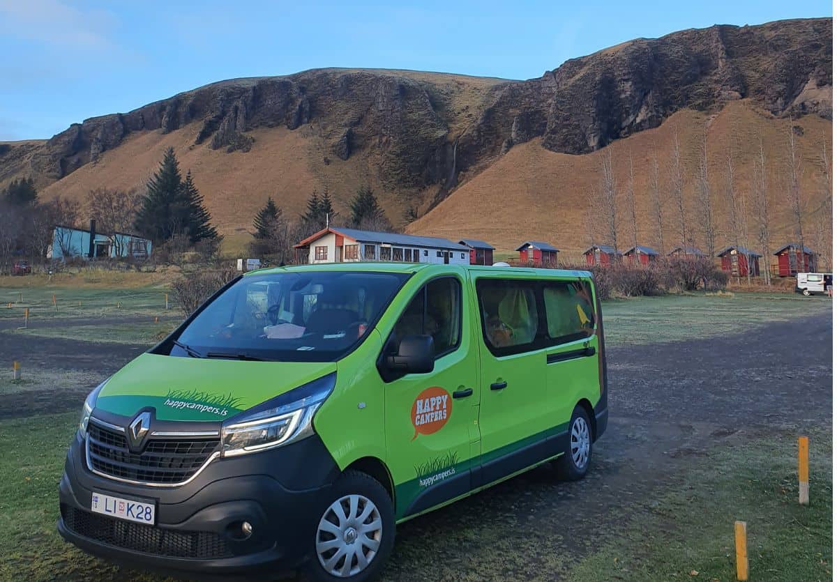 A campervan parked in front of hills in Iceland