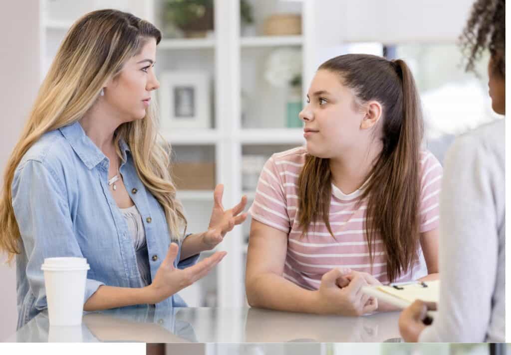 A mom and teen in discussion with a medical doctor