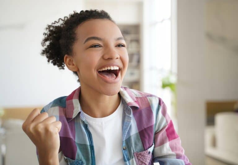 Ecstatic teen girl celebrates small win at home