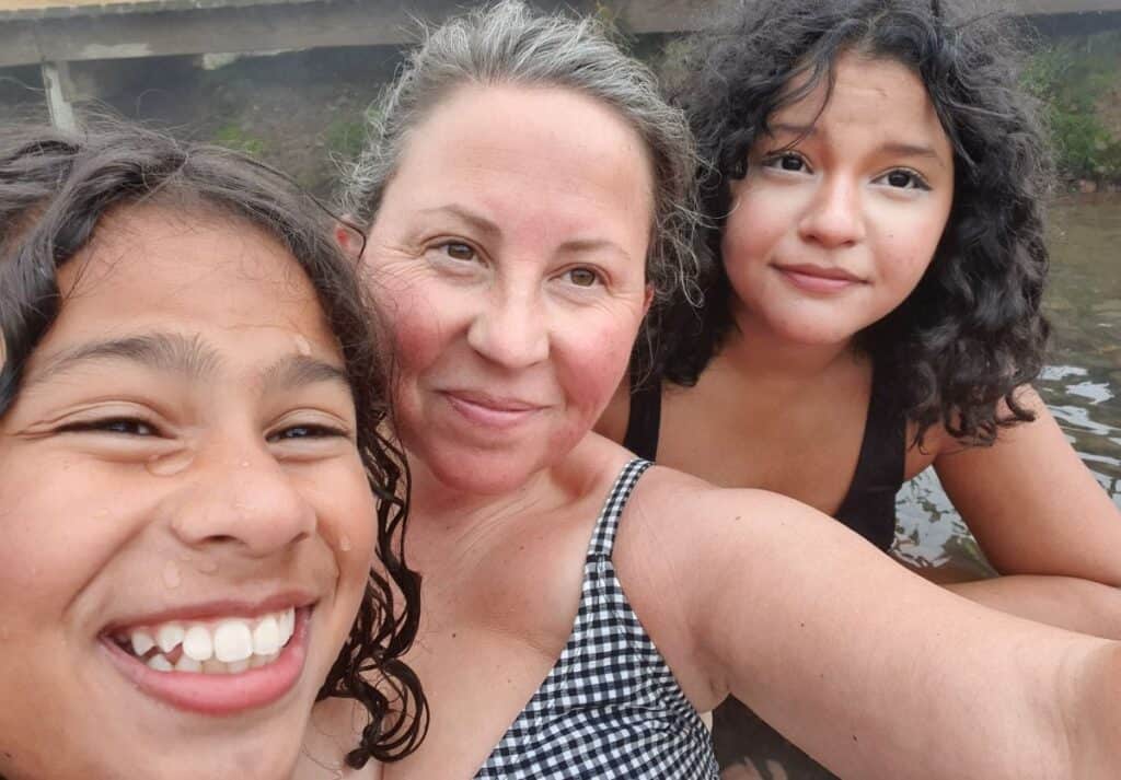 A selfie of a mom and two teens smiling