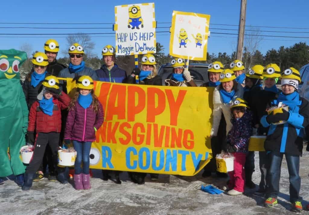 A family dressed as minions walking in a Thanksgiving parade