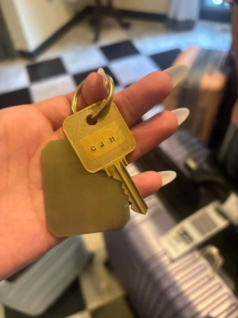 Teenager's hand showing the gold room key of the El Convento hotel in Old San Juan