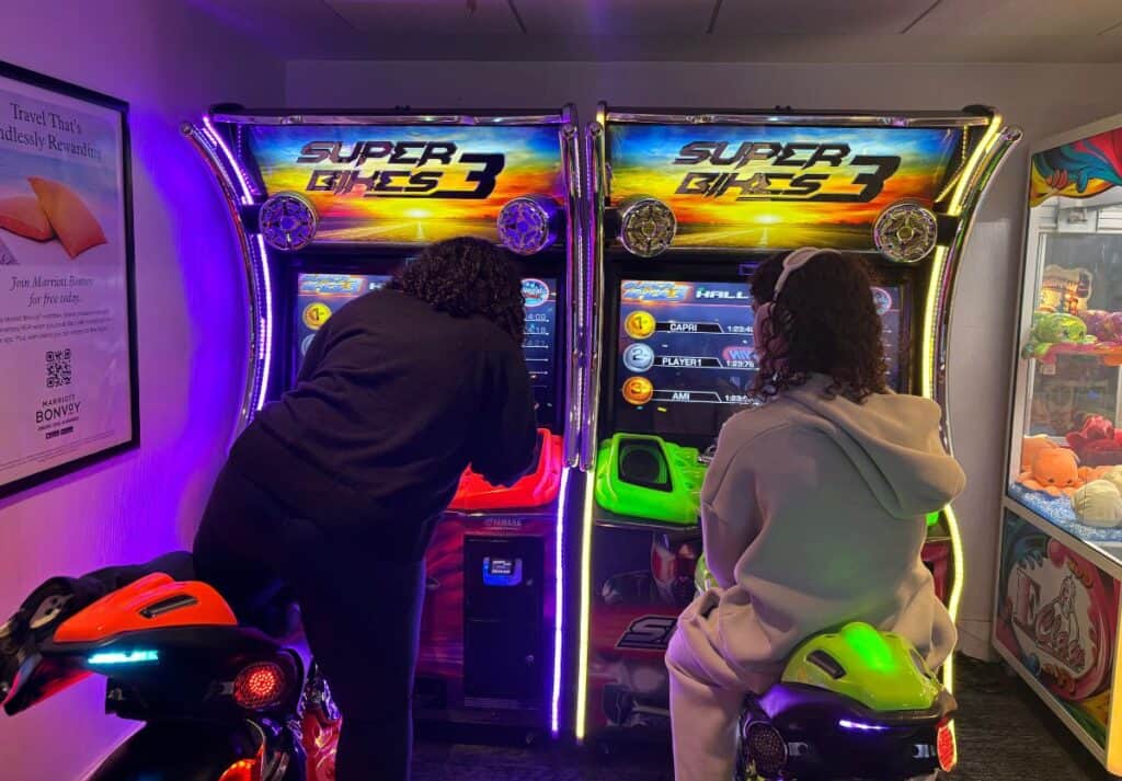 Teens riding a motorcycle video game at the Gaylord National Harbor