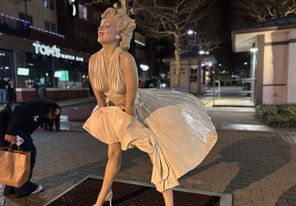 Marilyn Monroe statue at the National Harbor with a teen peering under her skirt!