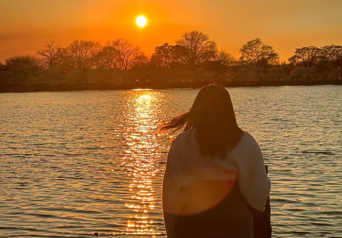 teen watching the sunset over a lake