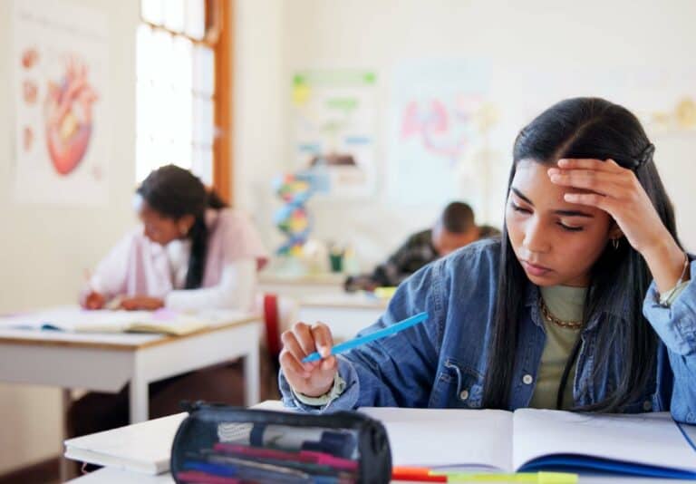 15 year old girl in a high school science classroom studying