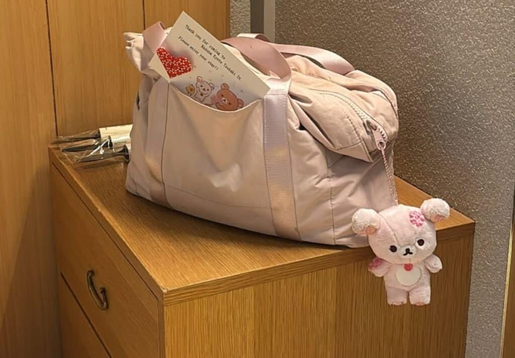 Rilakumma plushie and origami on Travel Bag on Nightstand at Nazuna Kyoto